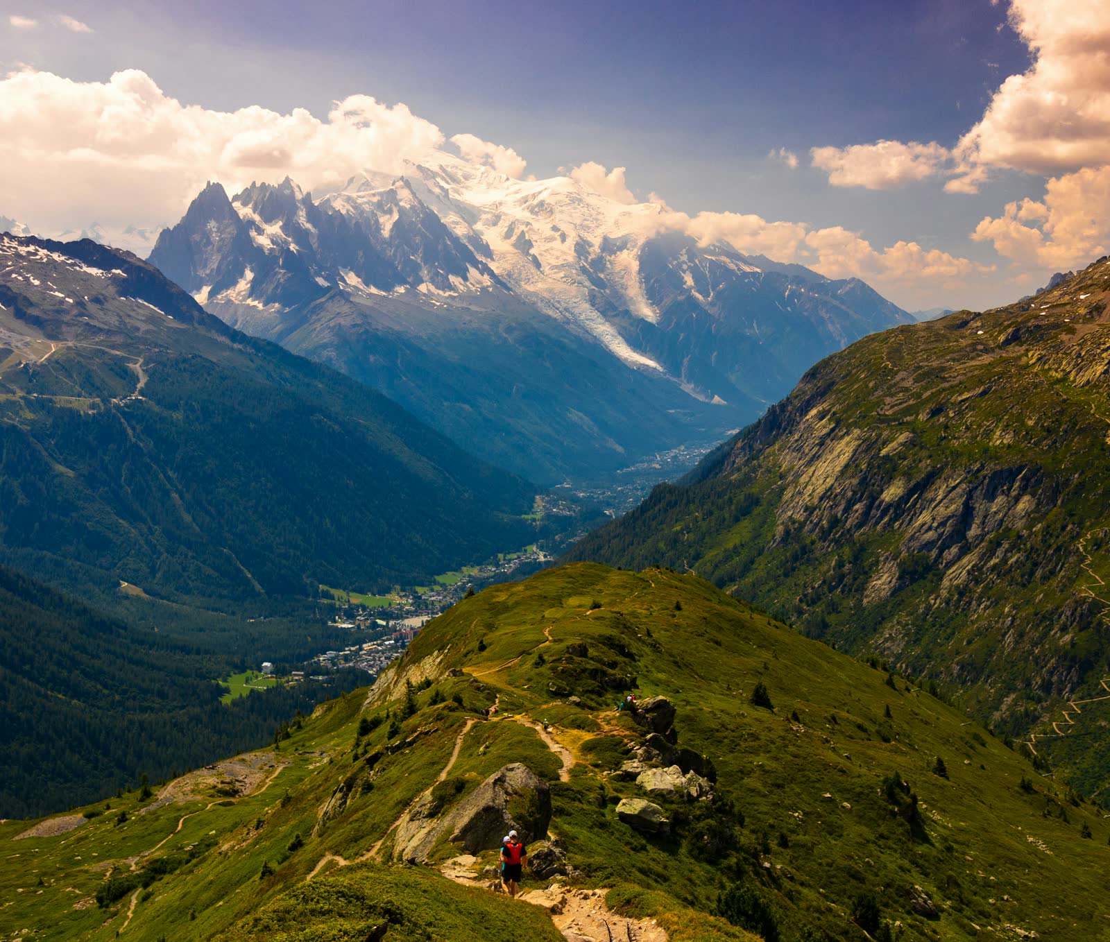 Hikers on a green summit in the French Alps in summer