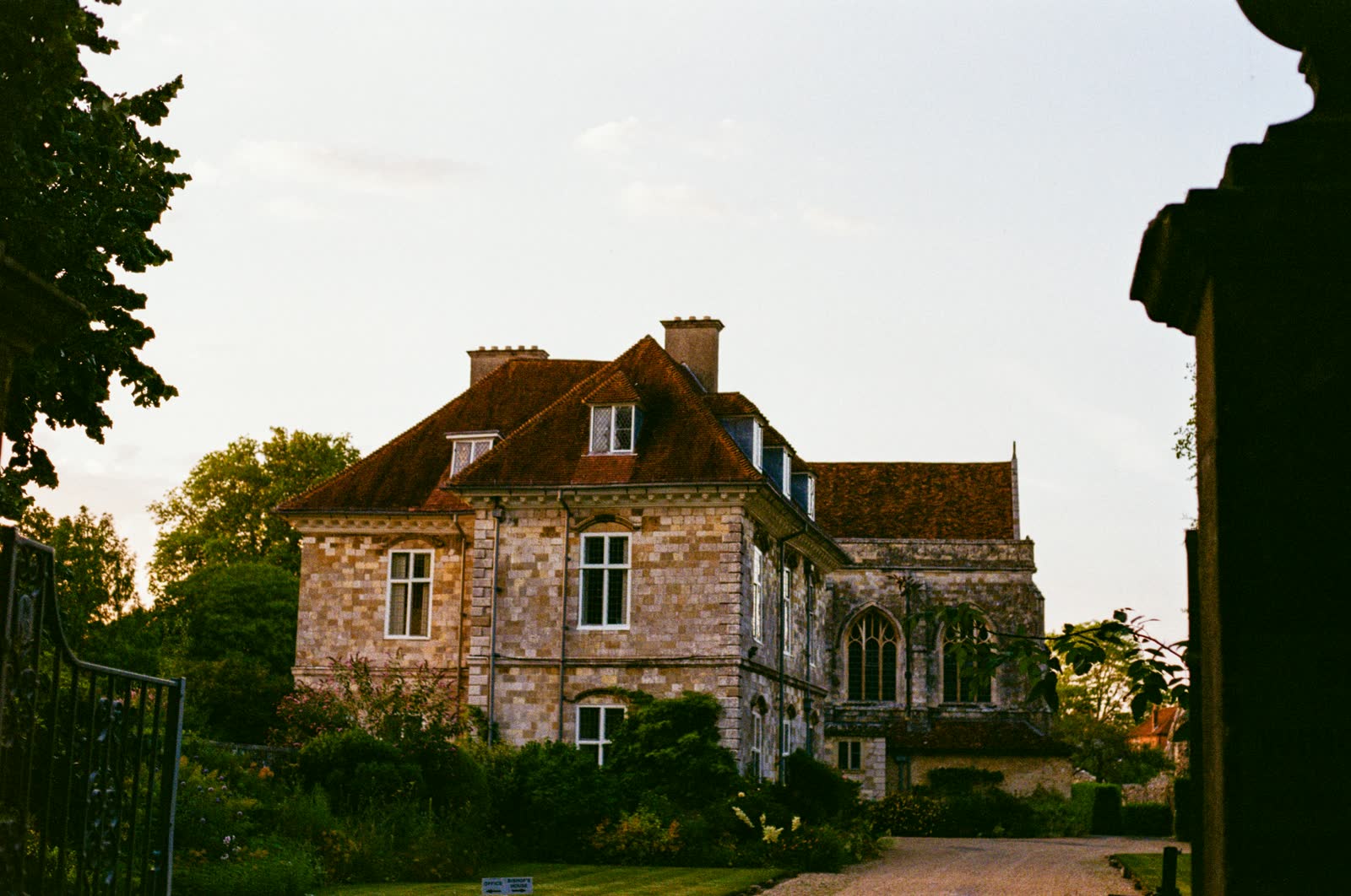 A stone manor house in golden light