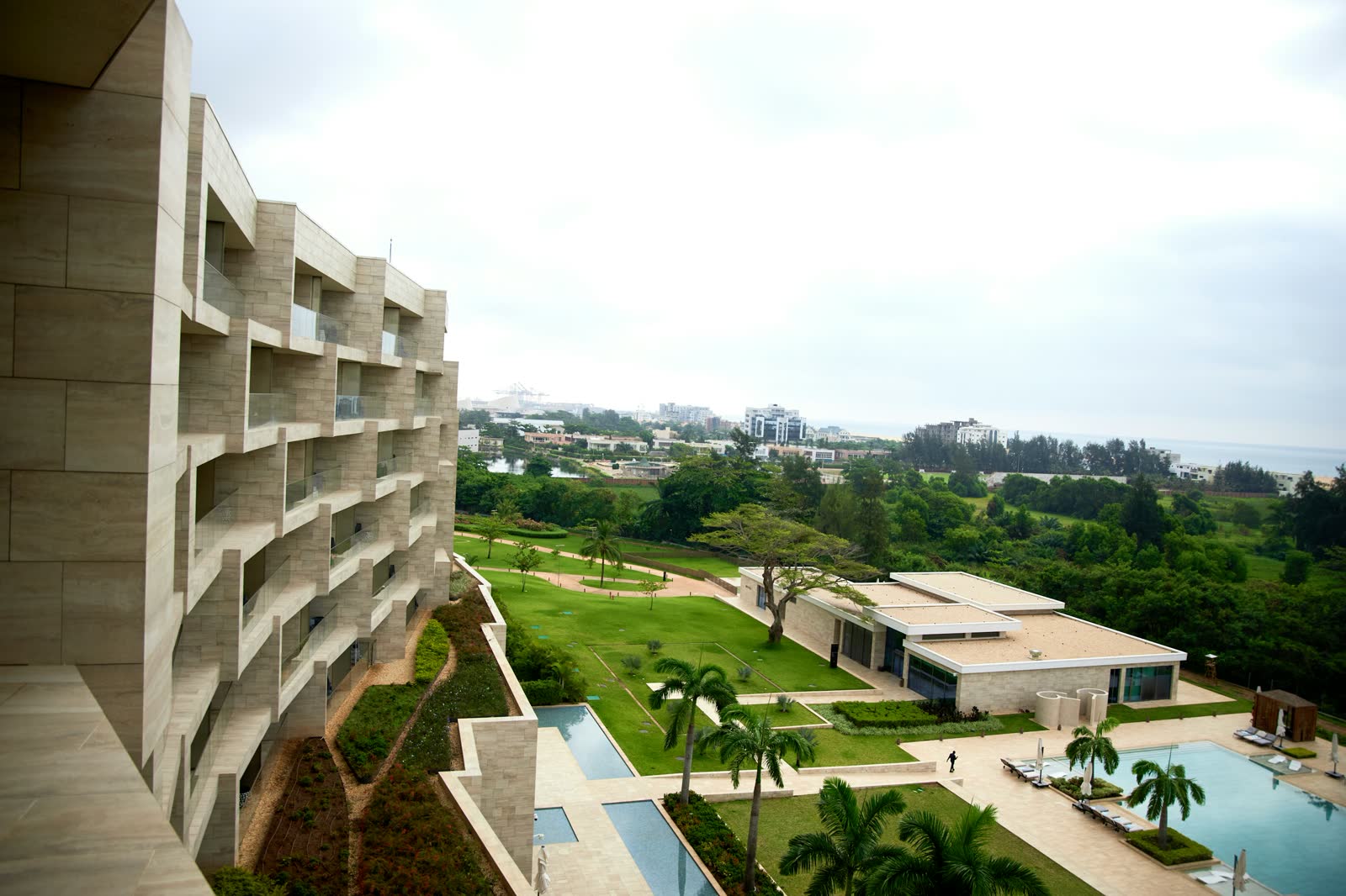 A family resort with a pool overlooking gardens and the sea