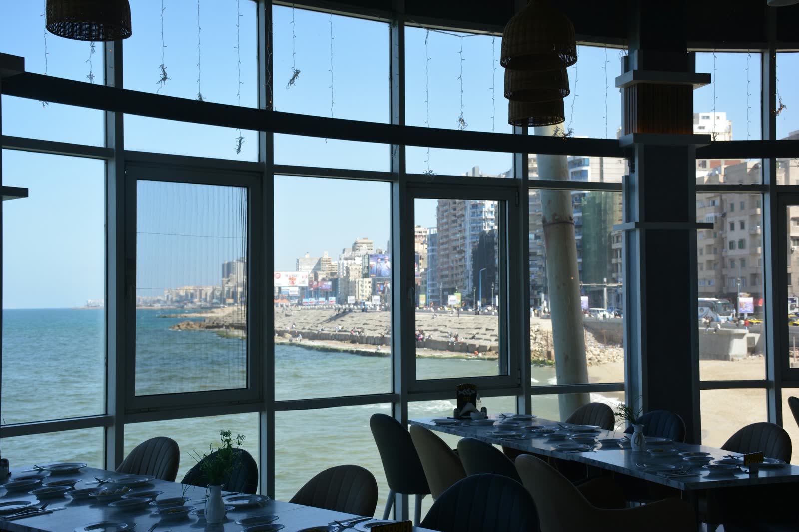 A restaurant with large windows overlooking the ocean